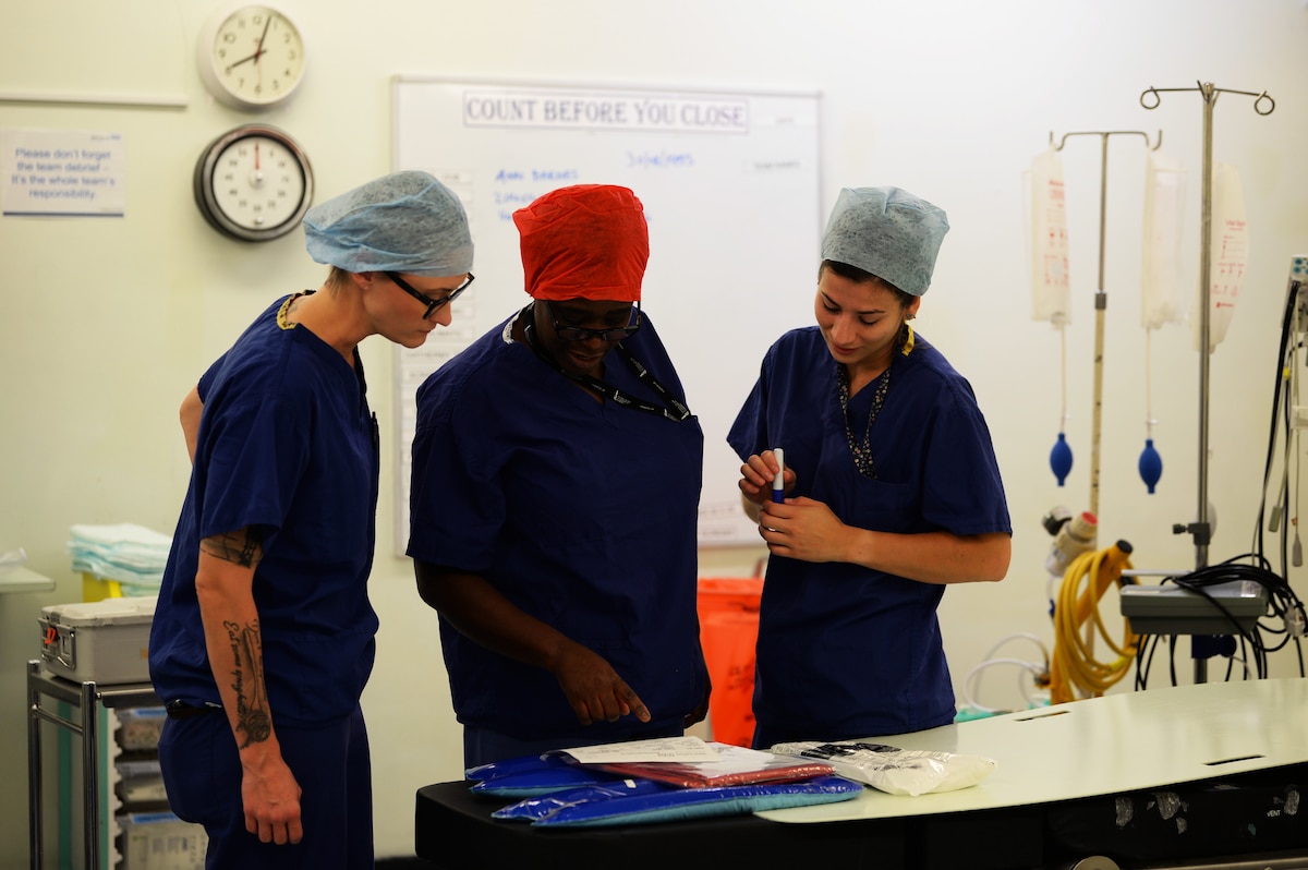 Tech. Sgt. Amy Templeton (left), noncommissioned officer in charge of the operating room for the 48th Surgical Operations Squadron, examines medical data with fellow surgical team members